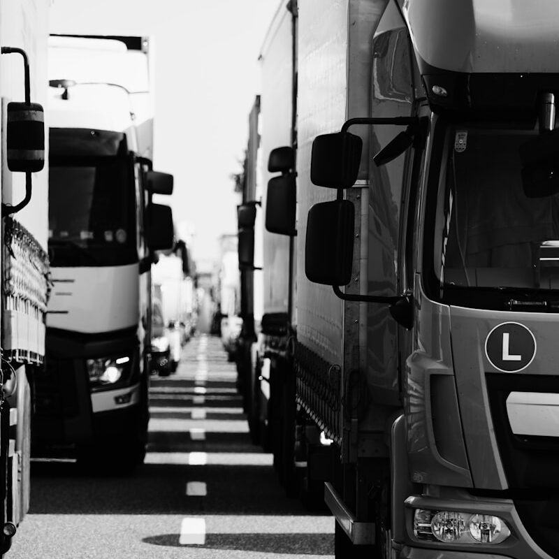 grayscale photo of cars on road
